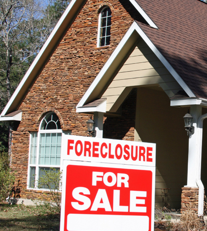 Local foreclosures edge down